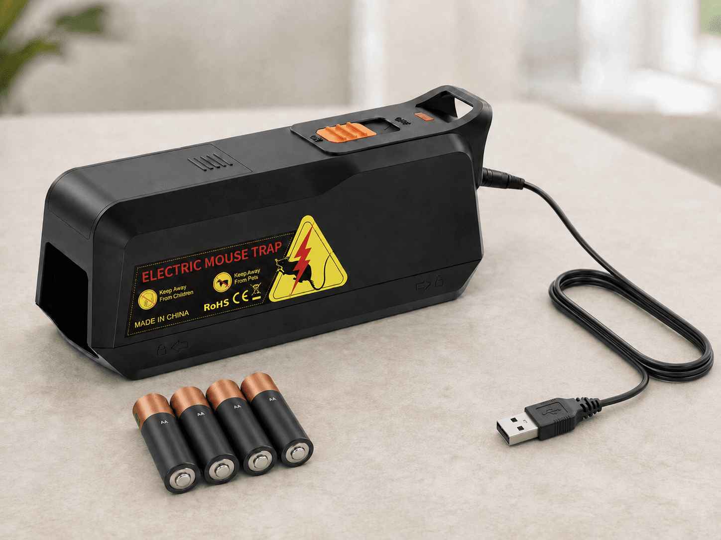 MK03 electric mouse trap with four AA batteries and an included USB-A-to-DC power cable