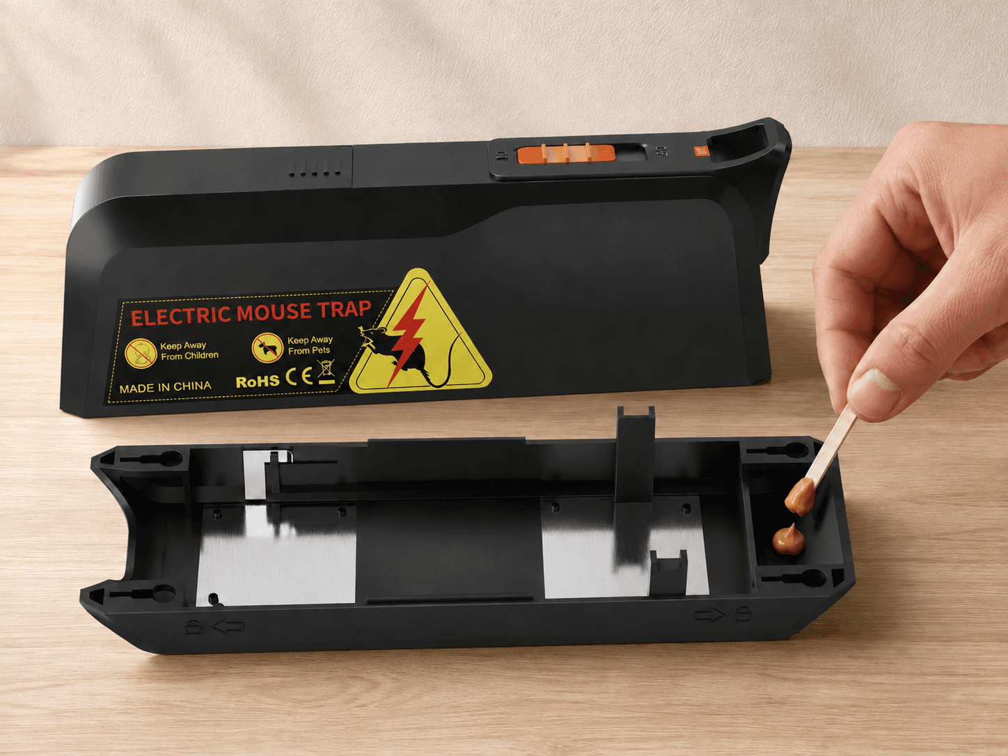 Adding bait to the MK03 bait slot with the bottom plate removed